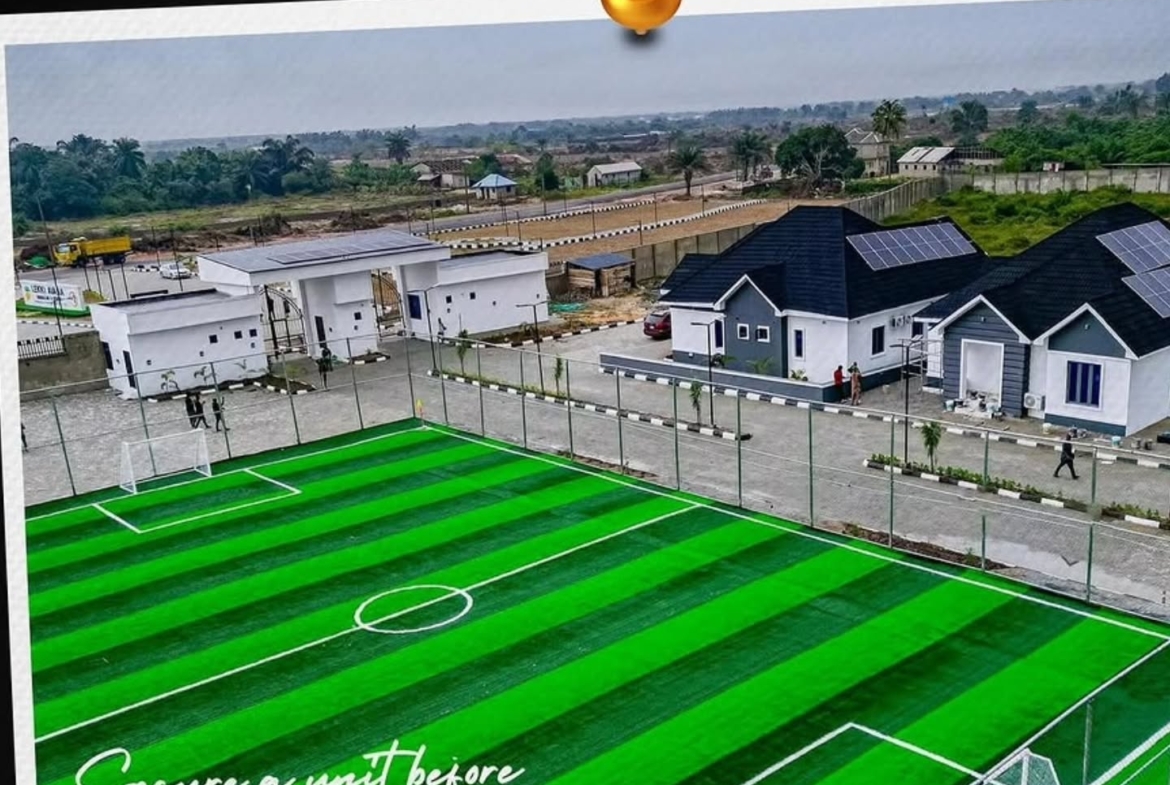Residential area with soccer field and houses.
