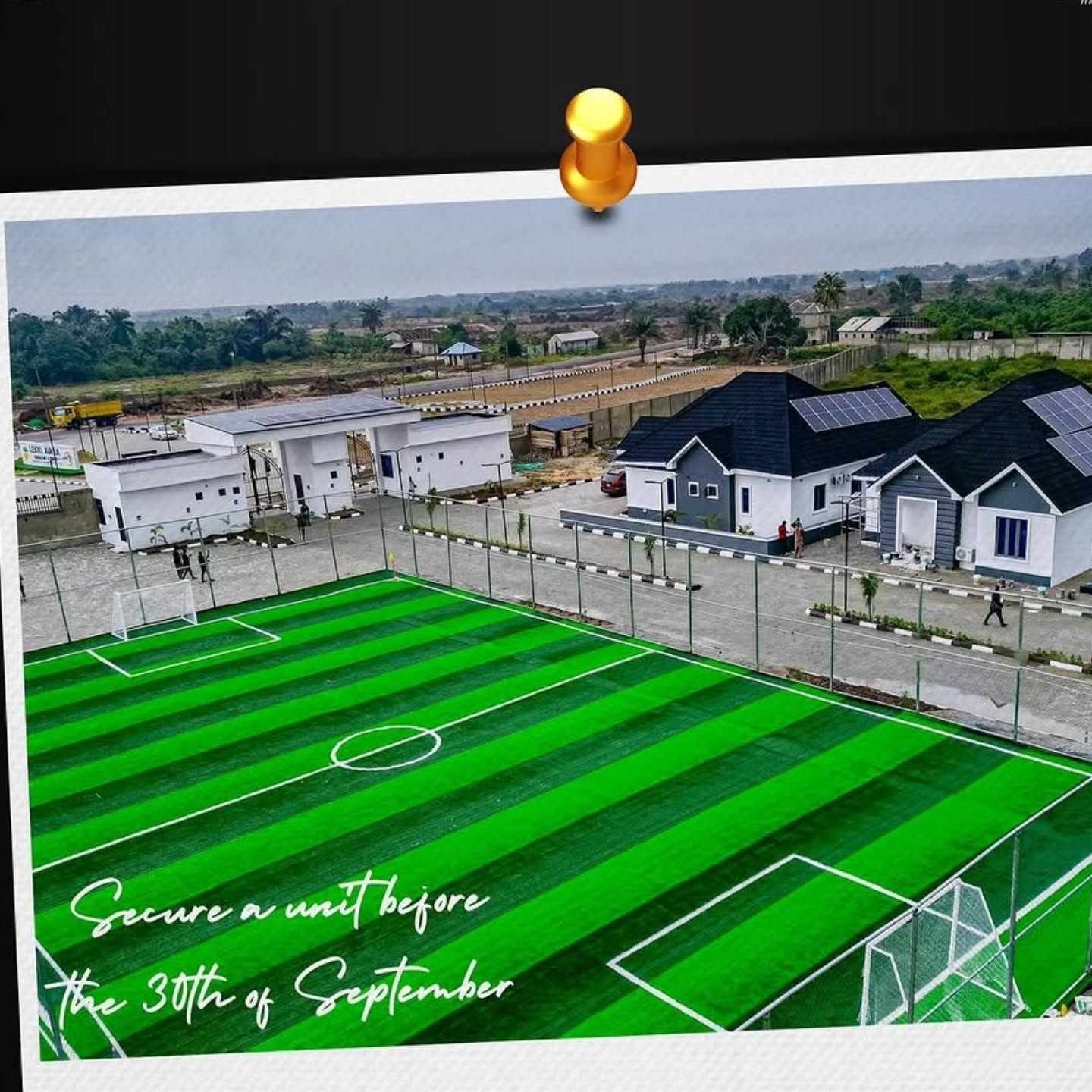 Residential area with soccer field and houses.